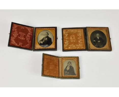 Three 19th century ambrotypes / daguerrotypes, each held in box form case, opening to reveal gilt framed portraits, two gentl