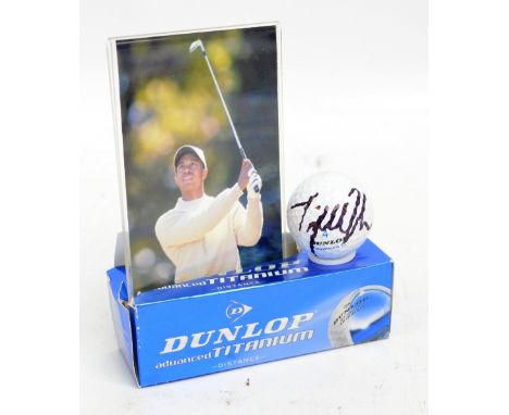 TIGER WOODS; a Dunlop golf ball autographed by Tiger Woods with black marker pen, with homemade display case and letter of au