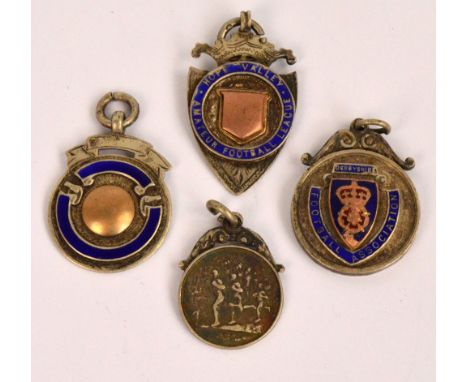 Four 9ct gold medallions relating to the Derbyshire Football Association including a shield shaped example inscribed "Medal C