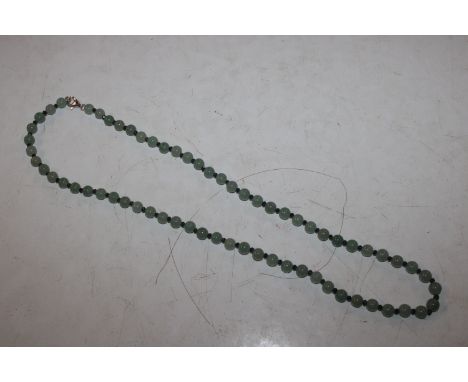 A jade bead necklace with silver clasp