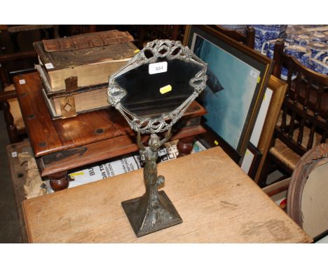 A brass figural Art Nouveau decorated mirror