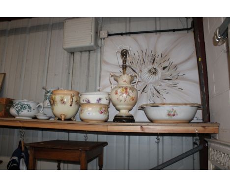A collection of various chamber pots, wash basins, jug, soap, dish, toothbrush holder, and a floral and gilt heightened decor