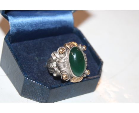 A white metal and yellow metal ring set with green stone, ring size R AF, approx. total weight 16gms 