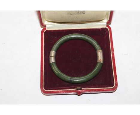 A jade and white metal mounted bracelet