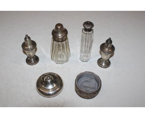 A silver topped sugar shaker and silver mounted powder bowl and cover, a silver topped dressing table jar; two Sterling silve