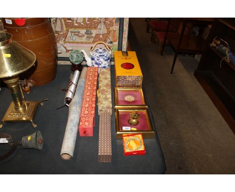 A faux jade puzzle ball in stand; two cased medallions; a hardstone bracelet; various scrolls; a blue and white tea pot and a