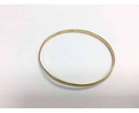 A 9ct gold diamond cut 2.5mm slave bangle, approx 8.4g (A13). Shipping category A.