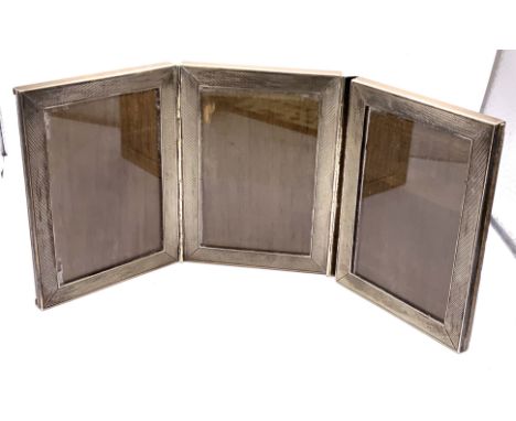 An engine turned Silver triple hinged photo frame, stamps S.835 (B), each panel 10.5cm x 7.5cm.