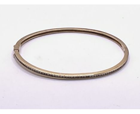 9ct gold diamond channel set bangle. Approx 8g. Postage Category B.