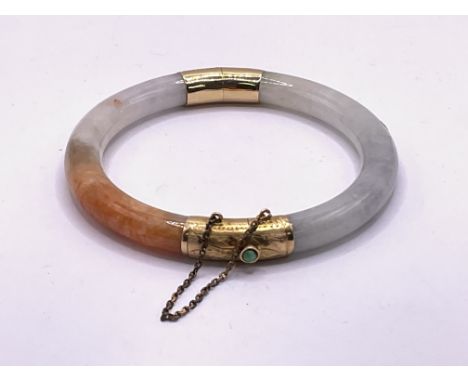 14ct gold multi-coloured jade bangle with safety chain. Postage category B. Approx 34g.
