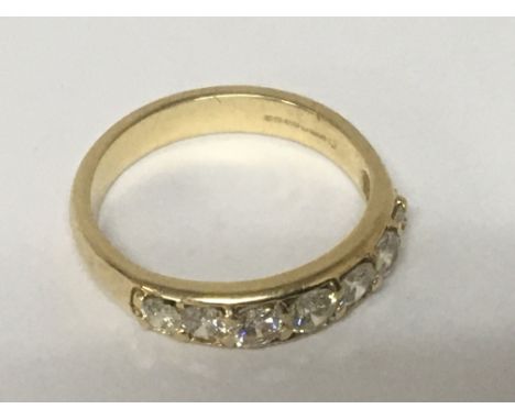 An 18carat gold ring set with a row of seven brilliant cut graduating diamonds. Weight 5g ring size R.