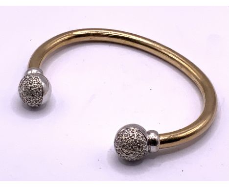 A ladies heavy 9ct gold and diamond set torque bangle, approximately 49g. (A)