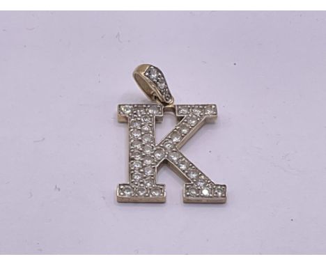 9ct gold cubic zirconia letter K. Postage A. Approx 5g.