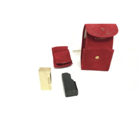 A 9ct gold Cartier lighter with box and service paperwork from Cartier in 2010. 78.10g Postage (A).