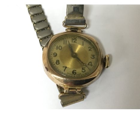 A vintage ladies 9carat gold watch with replacement strap not seen working.