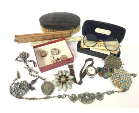 A collection of vintage items including a silver chained locket, costume jewellery consisting of brooches, cufflinks, a neckl