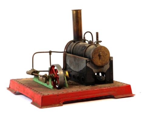 A live steam stationary steam engine 
With chimney, methylated spirits burner driving a single wheel with two pistons on red 