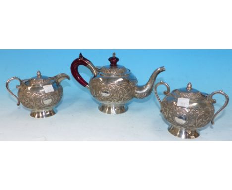 A Ceylon white metal 3 piece bachelor's tea service with embossed scrollwork decoration, amber coloured handle and knop to te