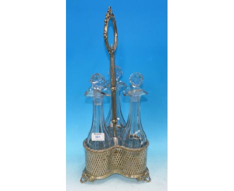 A set of 3 19th century faceted mallet shaped decanters in silver plated pierced trefoil stand with central ring handle
