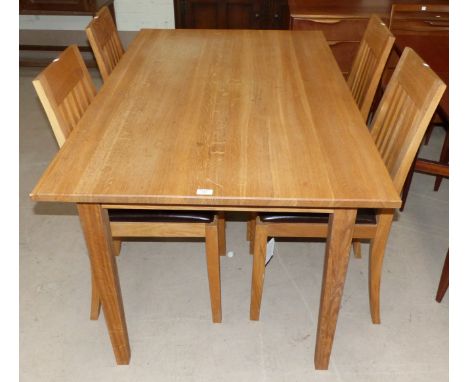 A modern light oak dining suite comprising rectangular table and 4 chairs