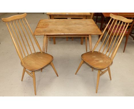 A light oak Ercol rectangular dining table with stretcher base and a pair of similar Ercol stick back dining chairs