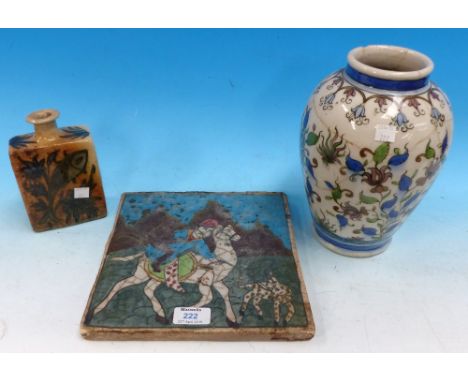 A glazed Persian tile decorated with figures on horseback, 9½" square; 2 similar pieces