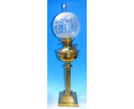 A Victorian reeded brass column oil lamp with etched shade and chimney