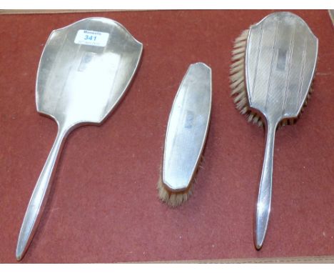 An engine turned silver back 3 piece dressing table set
