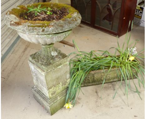 A reconstituted stone urn and trough