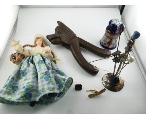 An assorted lot including silver hat pin stands and several hat pins vintage nut cracker dolls etc. Postage B