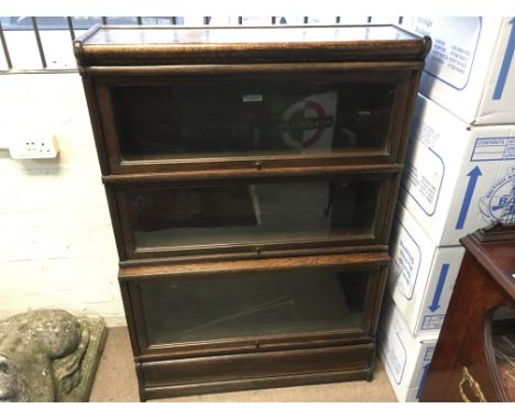 A globe wernicke three section bookcase.86 cm wide 124 cm tall.