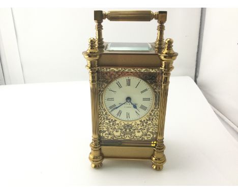 A Mappin and Webb carriage clock with floral fretwork frontage.