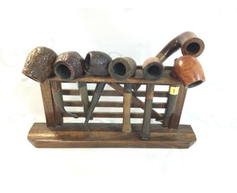 A gate style pipe holder with 7 pipes. Postage B