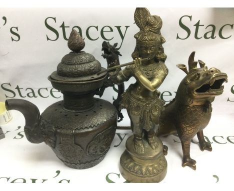 A large Oriental metal teapot, a brass dragon and a female Tibetan figure (3). Shipping category D.
