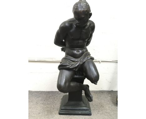 A bronze lamp base figure of a seated man in captivity. 50cm tall approximately. This lot cannot be posted