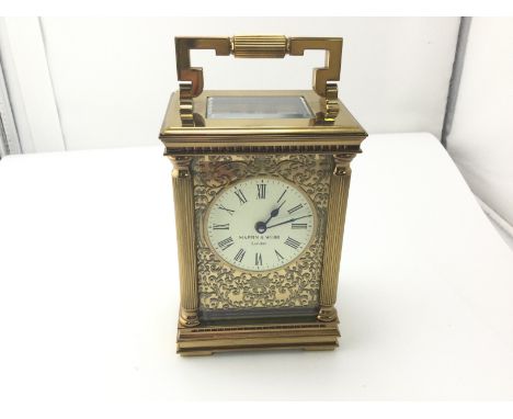 A Mappin and Webb carriage clock with floral fretwork frontage.