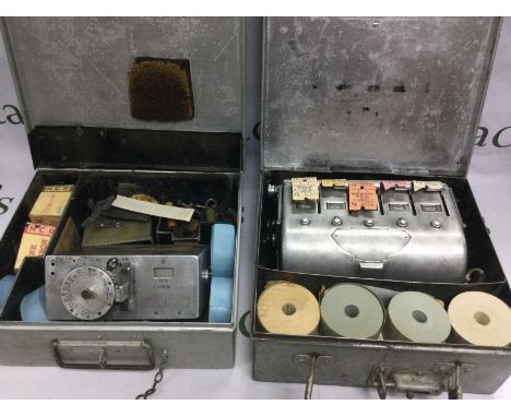 Two vintage bus conductor's ticket machines in original carry cases with rolls of unused tickets (2). Shipping category D.