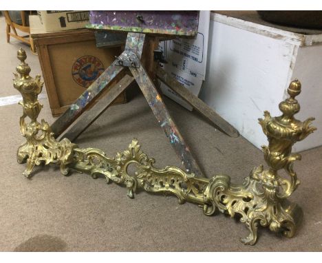 An ornate brass extending fender. Shipping category D.