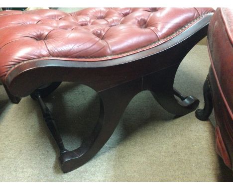Two X framed stools with button seats .