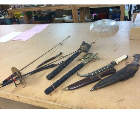 A collection of weaponry including a Mace, Fencing sabres, axe, Kurki, bone handled dagger. This lot cannot be posted