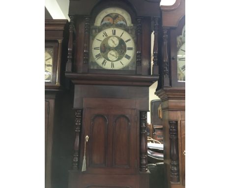 A Victorian mahogany long case clock the Arched  painted dial with moon roller  second subsidiarie dial and Roman numerals.