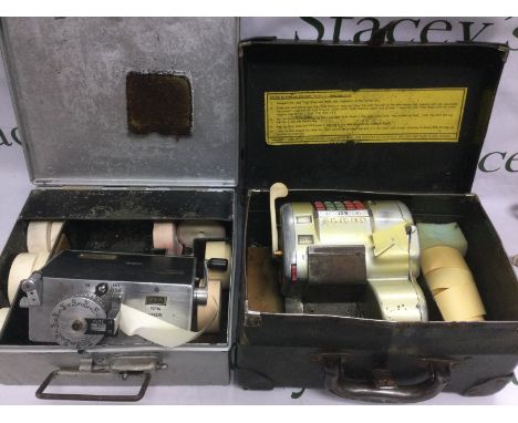 Two vintage bus conductor's ticket machines, one manufactured by Almex plus one other, unused rolls of tickets and both house