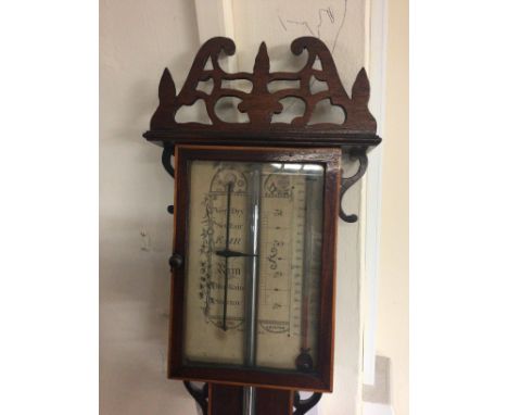A stick barometer with a pierced applied pediment with Mercury tube on a mahogany back board with cross banded  satin wood ed