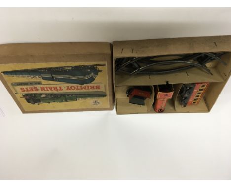 A Vintage boxed Brimtoy tin plate clockwork train set in a fitted box. Very good condition.