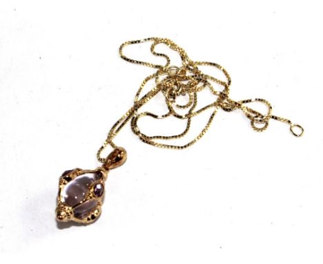An amethyst pendant on gold neck chain