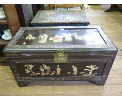 A stained camphorwood chest, with relief figural panels and bracket feet, 86cm wide 43cm deep, 46cm high