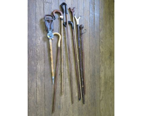 Seven handmade walking sticks, including one with antler horn handle, another with Banksia nut handle and a shooting stick (8