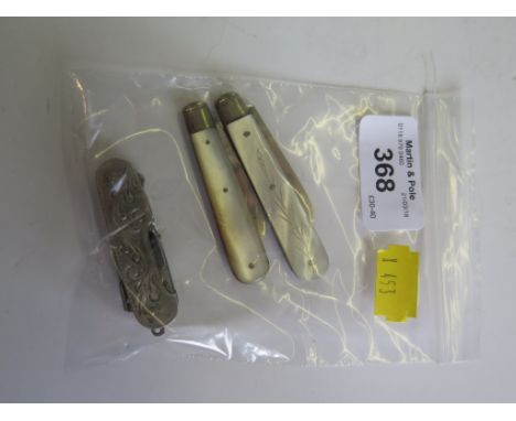 A Sterling silver multi fuctional pocket knife with scissors and two silver mother of pearl cased fruit knives, Sheffield 190