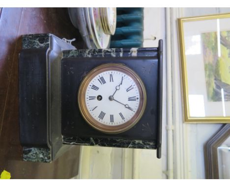 A black slate and green marble mantel timepiece, with enamel dial, 25cm high, a timber yoke and a brass covered coal box (3)
