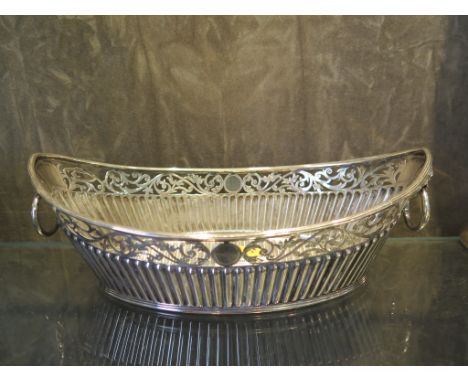 A Victorian boat shaped silver sweetmeat dish with half ribbed decoration and lion mask handles, Sheffield 1859